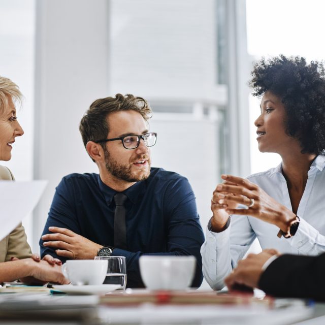 Give us difficult and well show you easy. Shot of a group of businesspeople sitting together in a meeting.